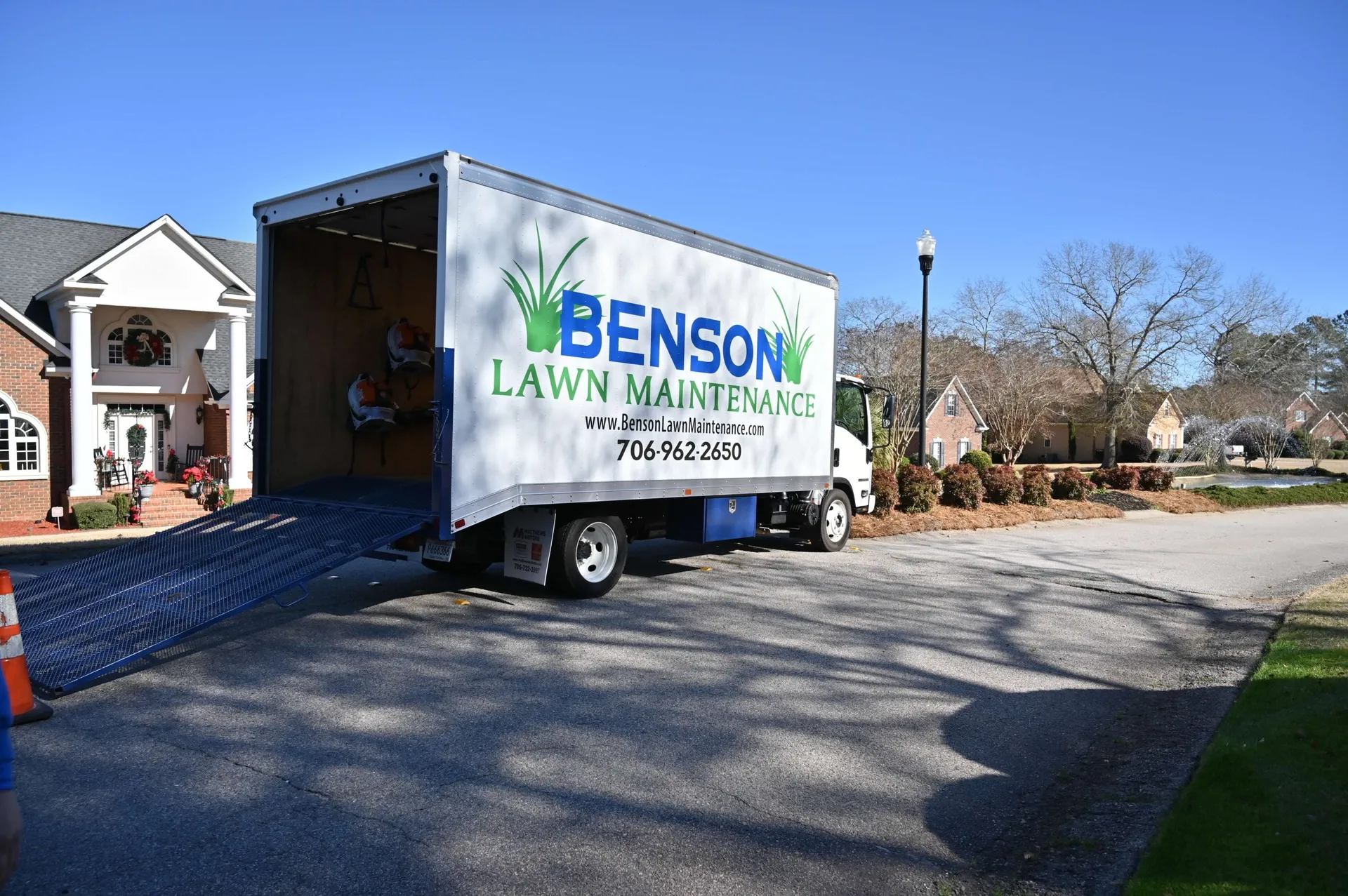 Benson Lawn Maintenance branded truck on a residential job site in the CSRA